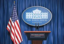 White House podium with American flag and seal.