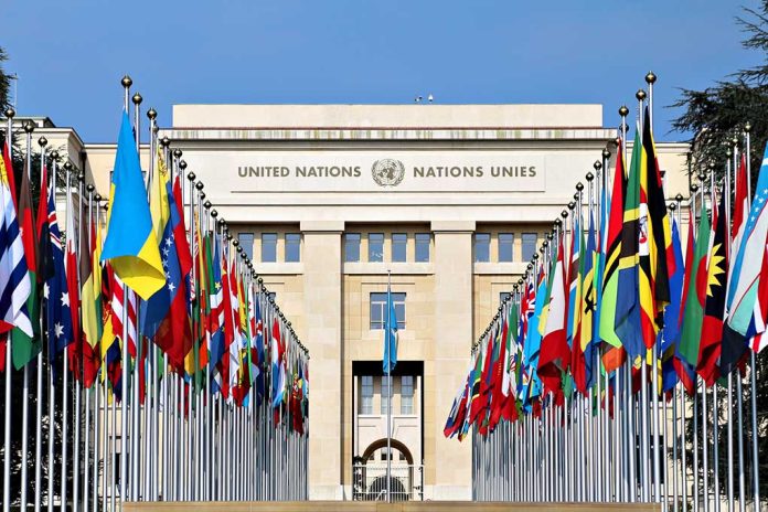 United Nations building with numerous national flags outside.