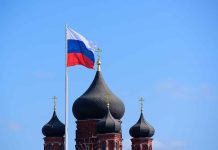 Russian flag next to church domes.