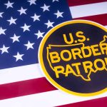 US Border Patrol logo on American flag background