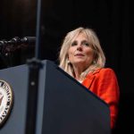 Person speaking at podium with Vice President seal.