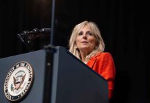 Person speaking at podium with Vice President seal.