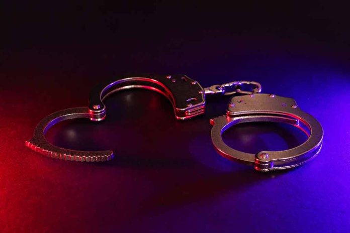 Handcuffs with red and blue dramatic lighting.