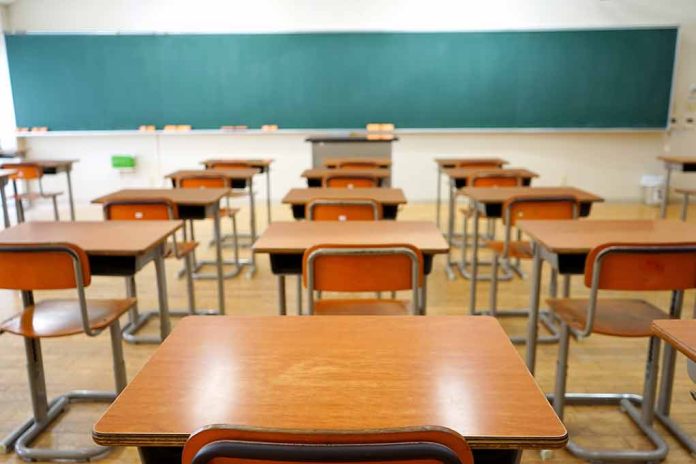 Empty classroom with desks and a chalkboard.