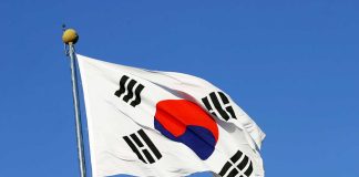 South Korean flag waving against clear blue sky.