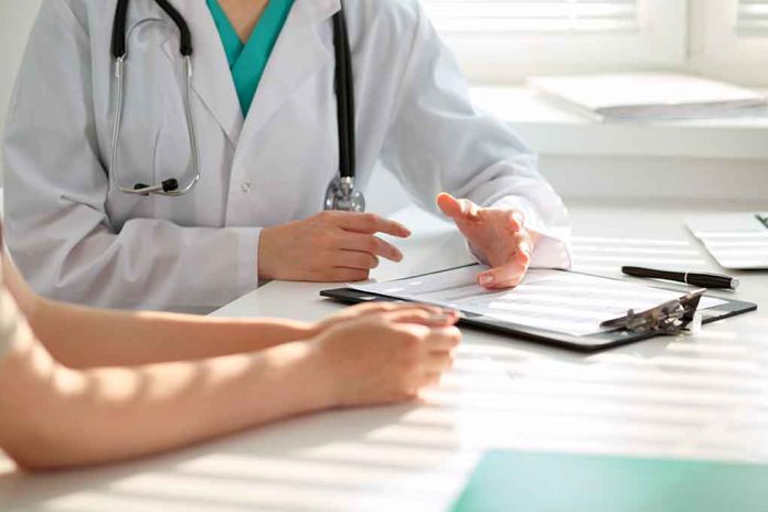 Doctor consulting patient with clipboard and pen.