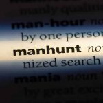 Manhunt definition in a dictionary underlined with light