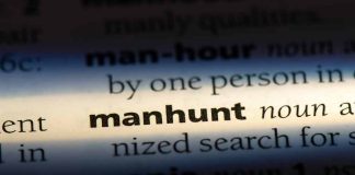 Manhunt definition in a dictionary underlined with light