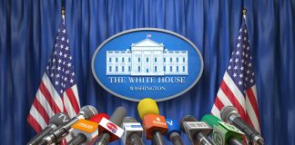 Multiple microphones at White House press briefing podium.