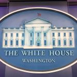 The White House emblem with blue background.