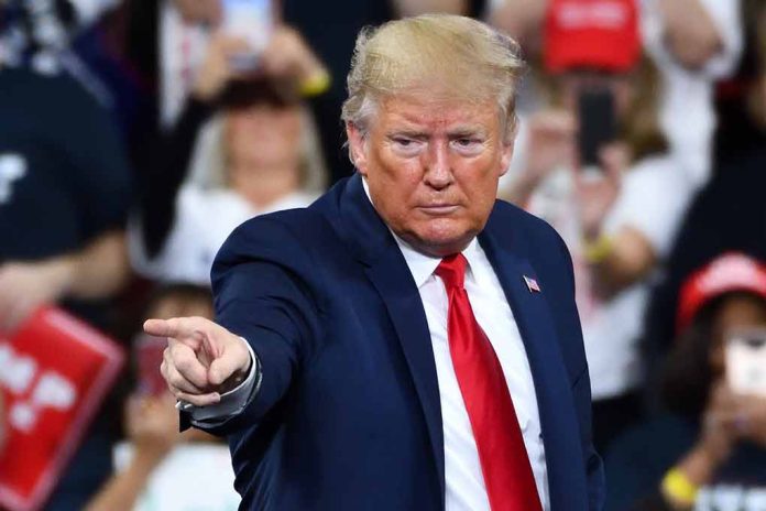 Man in suit pointing at crowd during event