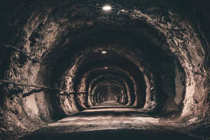 Dimly lit underground tunnel with rocky walls.