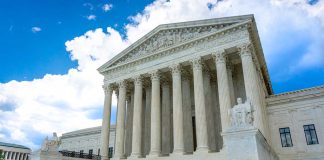 White marble building with columns under blue sky