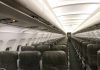 Empty airplane cabin with rows of seats.