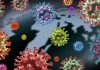 Colorful virus particles with a dark world map backdrop