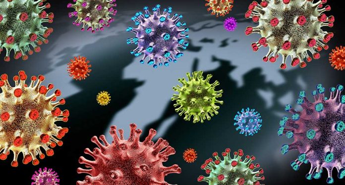 Colorful virus particles with a dark world map backdrop