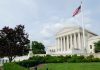 Government building with columns and American flag flying