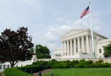 Government building with columns and American flag flying