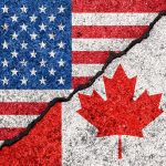 USA and Canada flags with a crack dividing them