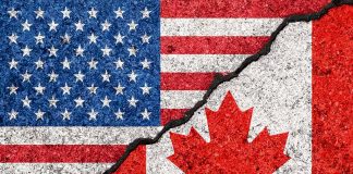 USA and Canada flags with a crack dividing them