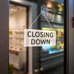 "Closing Down" sign on a shop door.