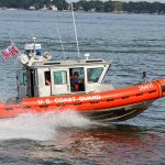 U.S. Coast Guard boat speeding on water.