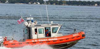 U.S. Coast Guard boat speeding on water.