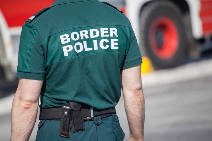 Person in "Border Police" uniform standing outdoors.