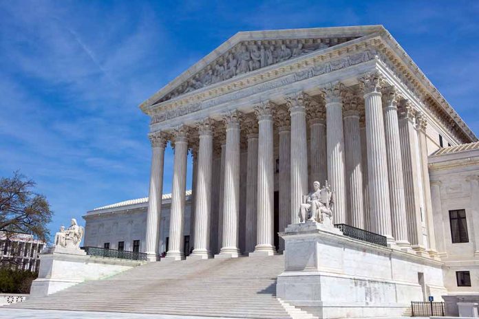 U.S. Supreme Court building with statues and columns.