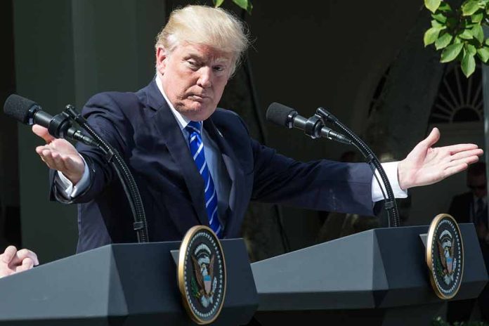 Man gesturing at two podiums outdoors.