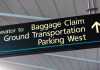 Airport sign for Baggage Claim and other destinations.