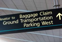 Airport sign for Baggage Claim and other destinations.