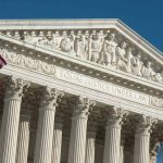 US Supreme Court building with American flag