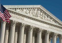 US Supreme Court building with American flag
