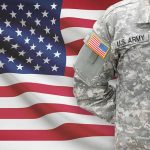 US Army soldier in camouflage with American flag