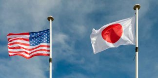 USA and Japan flags flying on flagpoles