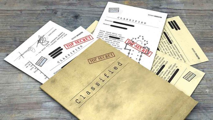 1099529729 featured image Classified documents with "Top Secret" stamps on wooden surface.