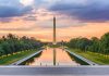 Monument and reflecting pool at sunset with trees