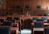 Empty courtroom with wooden furnishings and judge's bench