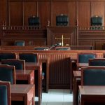 Empty courtroom with wooden furnishings and judge's bench