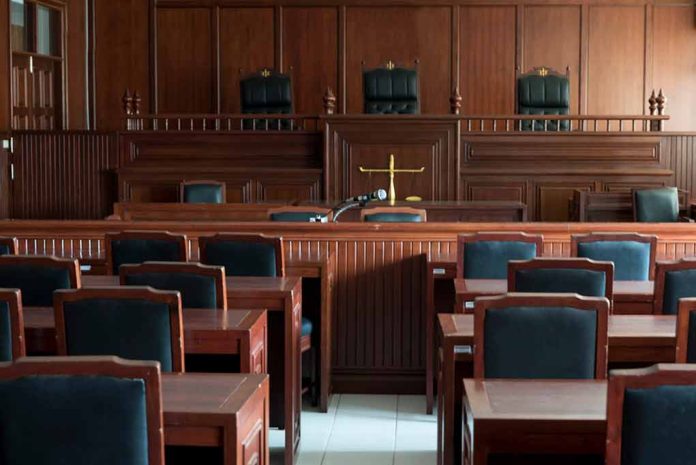 1154521519 featured image Empty courtroom with wooden furnishings and judge's bench