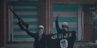 People holding and waving a black flag.