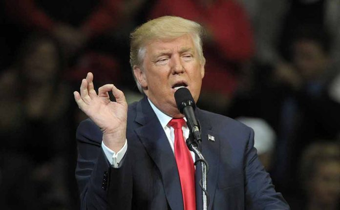 1427778662 featured image Person speaking at a microphone, gesturing with hand.