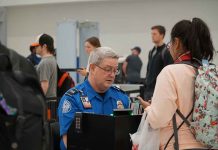 TSA agent checks passenger s documents at airport security