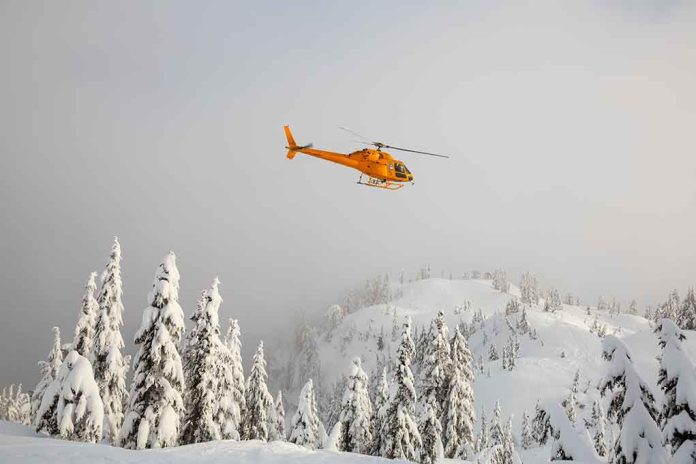 1653667153 featured image Yellow helicopter flying over snowy evergreen forest.
