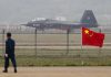 Jet with 31001 marking behind barbed wire fence