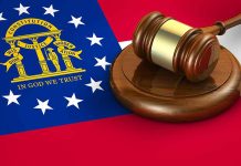 Georgia flag and judge's gavel on wooden base