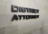 District Attorney sign on stone wall
