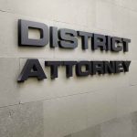 District Attorney sign on stone wall