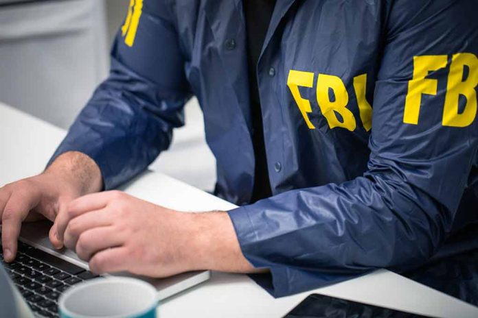 629482379 featured image Person in FBI jacket typing on a laptop.